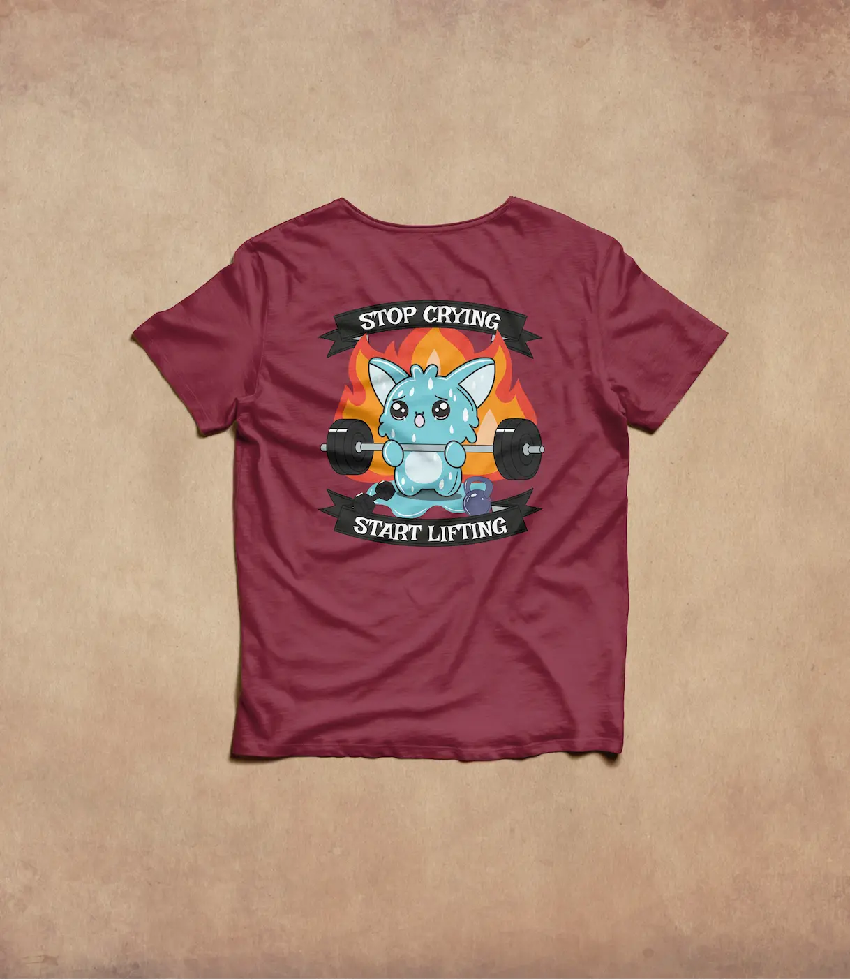 Tshirt Bordeaux, avec en illustration une créature bleue mignonne qui fait du crossfit avec le slogan " Stop Crying Start Lifting "